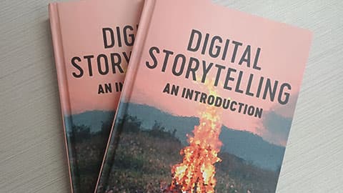 Two copies of Leah Henrickson's book overlapping each other. A digital image of a fire with text that reads Digital Storytelling: An introduction